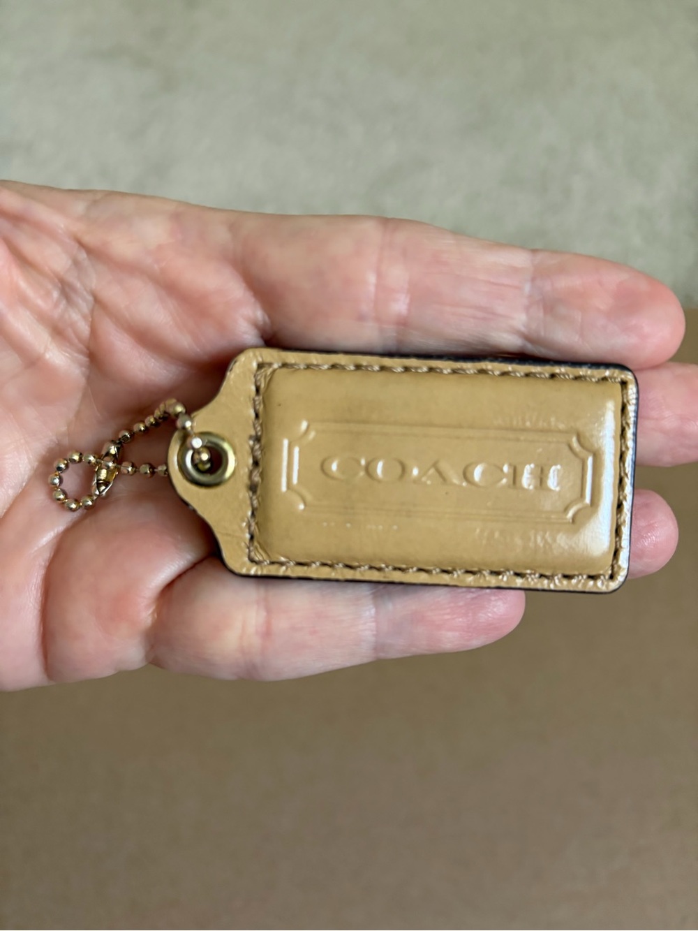 COACH Tan patent Leather Embossed Hangtag with Gold Ball Chain